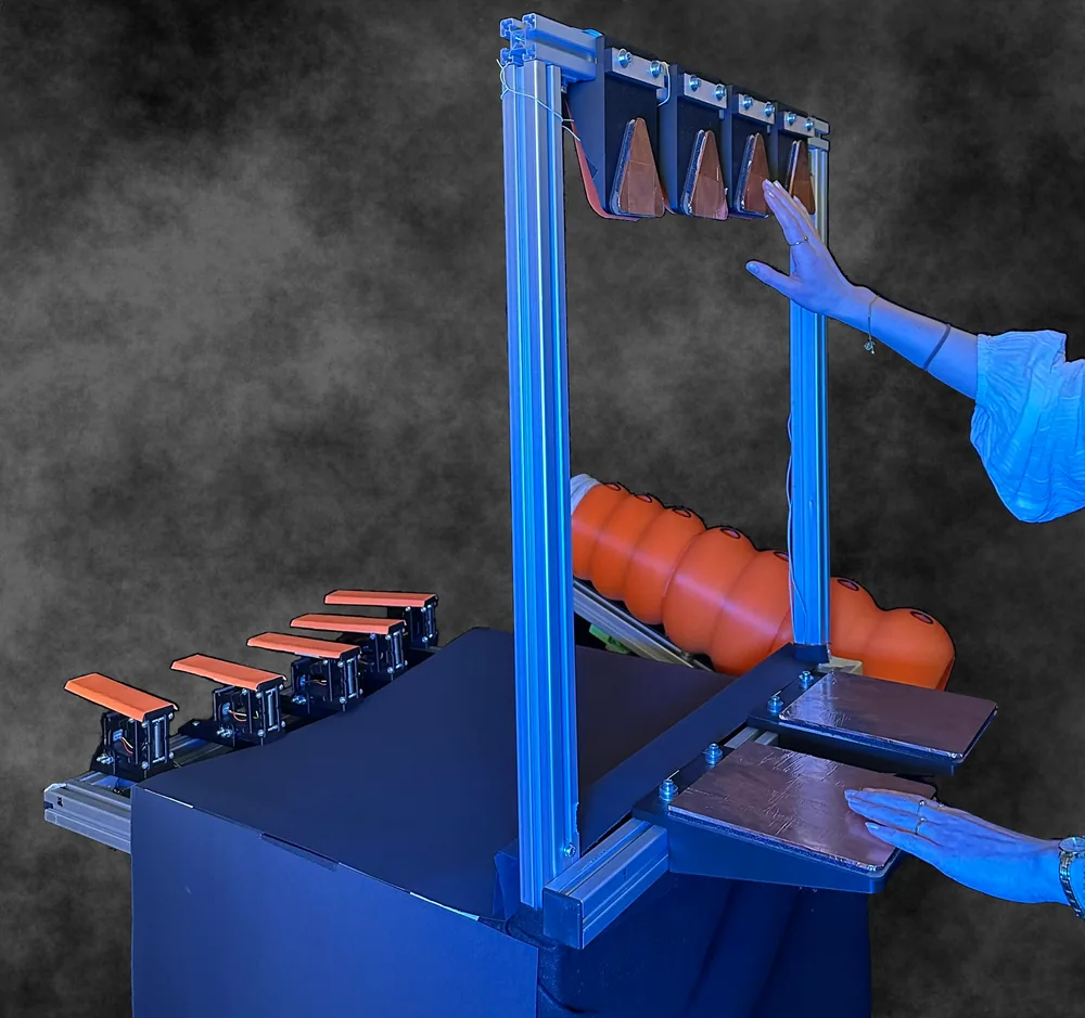 Feeling Connected: Designing Instruments and Haptic Feedback for Collaborative Music Exhibits