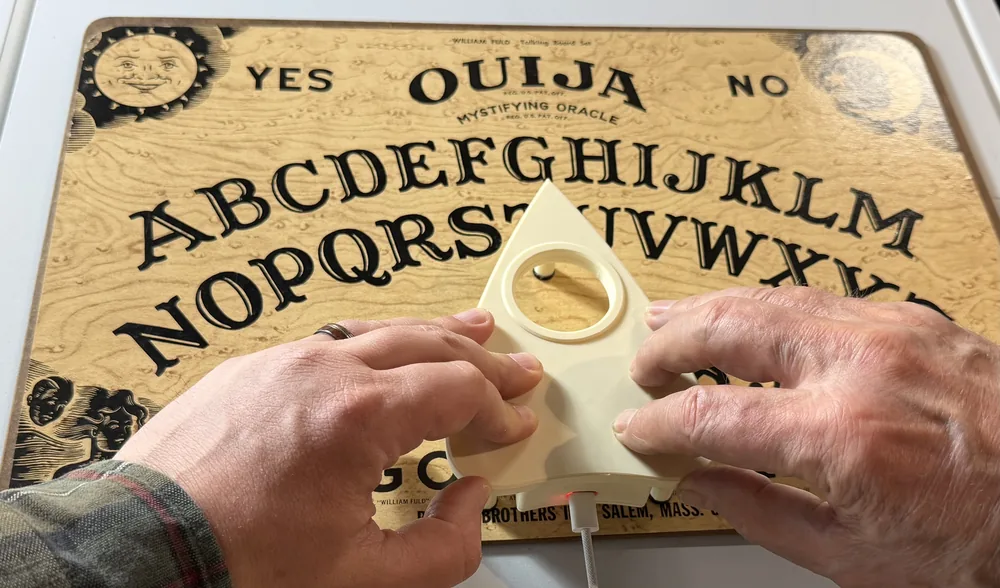 Host Your Ghosts: Recontextualizing the Ouija Board as a Communal NIME for Music Performance